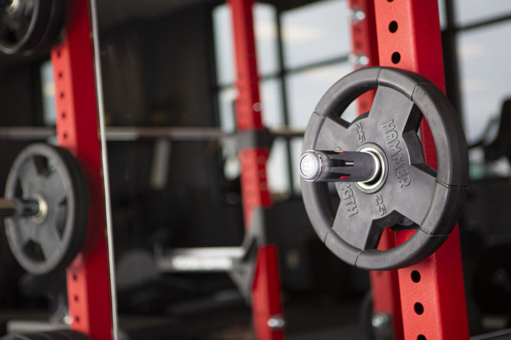 Close-up of 25 pound barbell on a weight rack