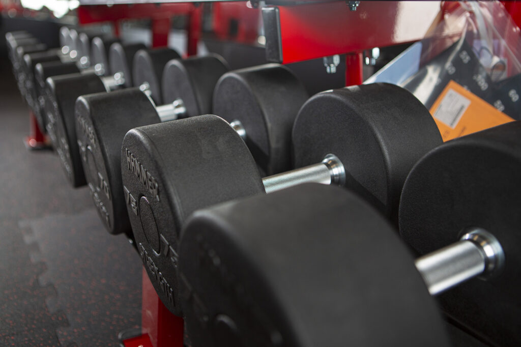 A close-up of a row of weights in a rack