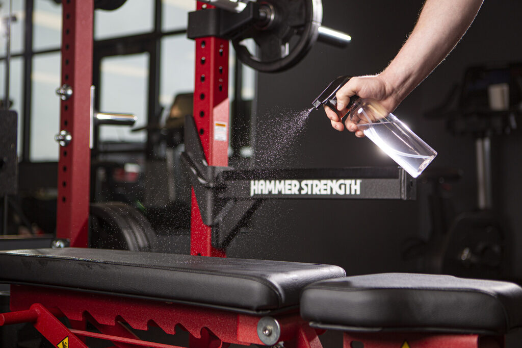 Cleaning solution being used to sanitize gym equipment