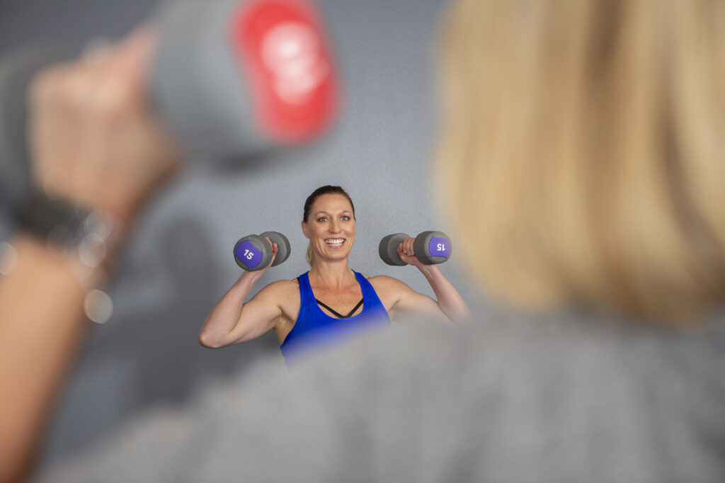 Fitness instructor leading a group fitness class