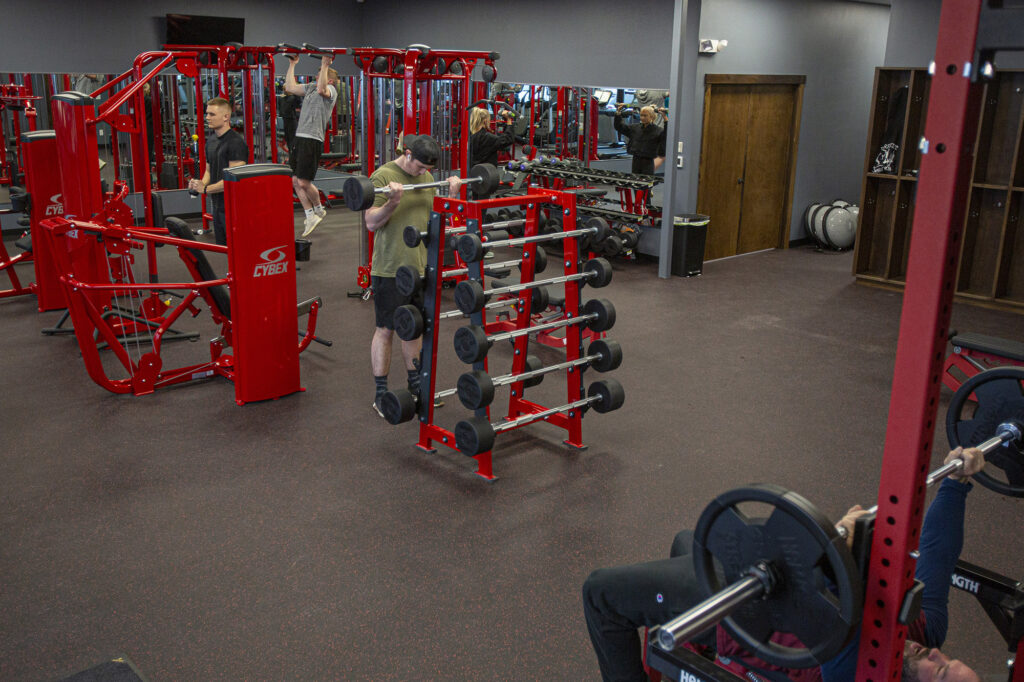 Gym-goers using equipment to exercise