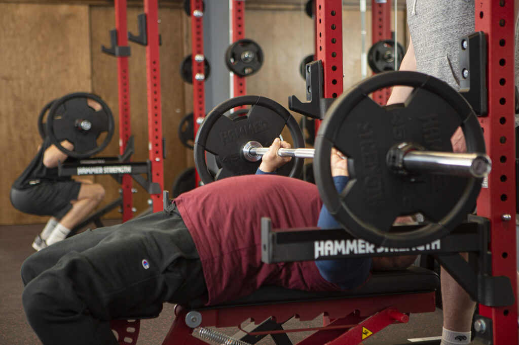 People using barbells to lift weights and exercise